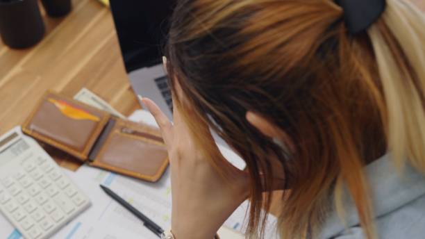 istock Struggle woman opening empty wallet  having financial problems paychecks paper receipt bill statement ,calculating on smartphone for monthly expenses debt,planning budgets of monthly personal balance at home 1550254090