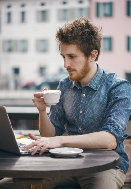 istock Young man connecting with a laptop at the bar 1550262380
