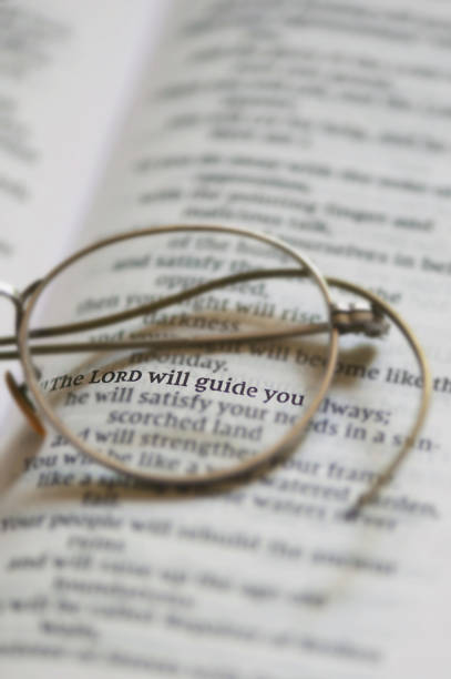 Reading a book after hard working day. Glasses on a book. Open book with glasses