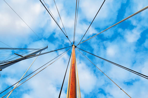 masts of sailing yachts without sails with anchoring ropes. view from below. - repairing sky luxury boat deck imagens e fotografias de stock