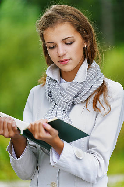 istock beautiful woman reading green book 155027480