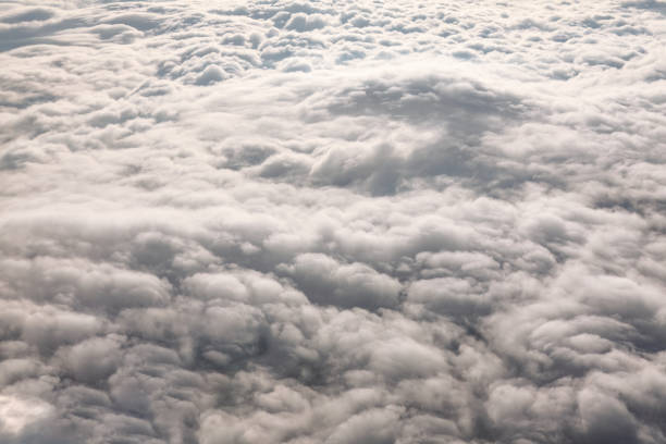 Cloudscape view from the window of an airplane flying above the clouds