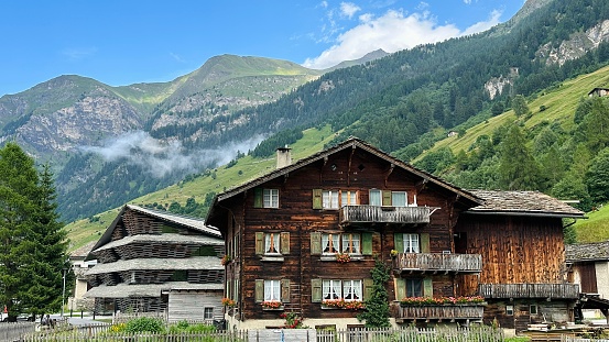 Vals, Switzerland - July, 12th - 2023: typical house and a new office building.