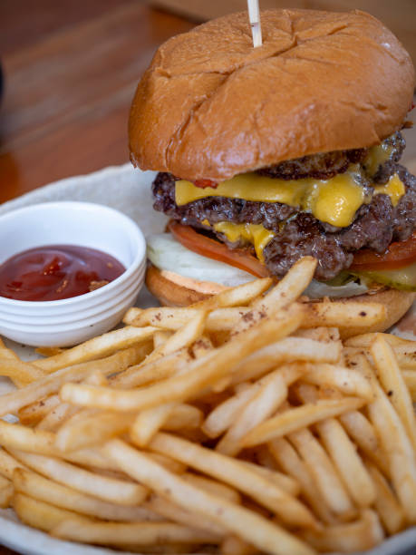 istock Hamburger with fries served on plate 1550304102