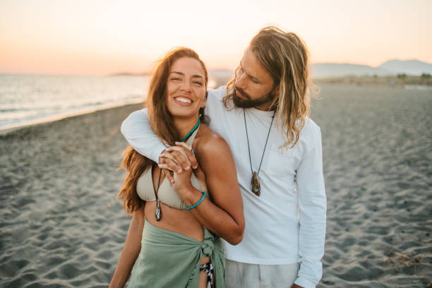 istock Couple walking by the beach 1550309818