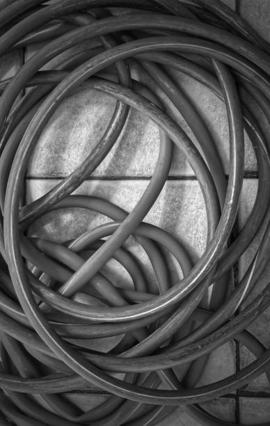 istock Old blue water rubber hose on the floor, object background 1550311516