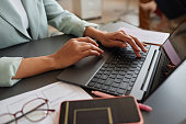 Closeup of black businesswoman using laptop and typing