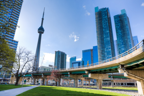 Low angle view of downtown Toronto with CN tower in background.\n[url=/search/lightbox/8385719][IMG]http://farm6.static.flickr.com/5209/5368284865_58507fbb8c.jpg[/IMG][/url]