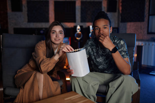 istock Young couple watching movie together 1550325449