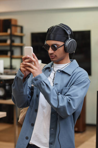 istock Young black man choosing smartphone in tech store 1550325466