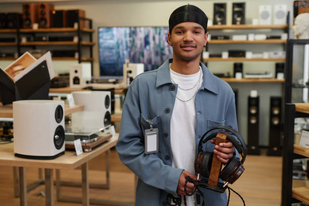 istock Black young man working in music store and looking at camera 1550326008