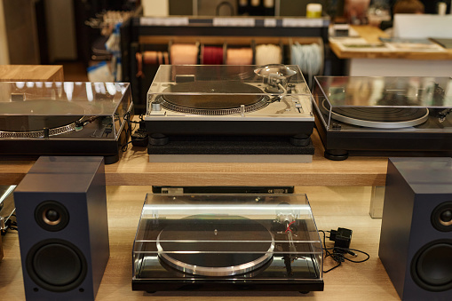 Background image of brand new vinyl record players on display in music store, copy space