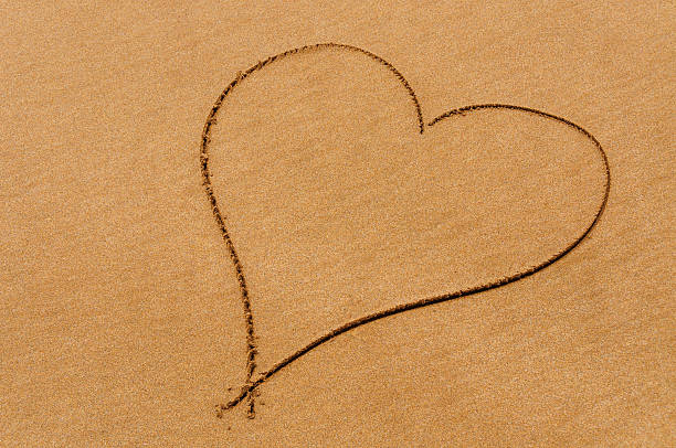Heart in sand stock photo