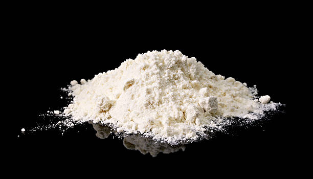 White flour on reflective black background stock photo