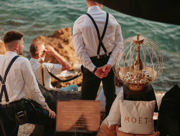 Moet et Chandon champagnes promotion on interior of luxury open-air restaurant on Adriatic sea coast. Waiters are men in immaculate white shirts with suspenders. Summer. Rovinj, Croatia - July 7, 2023 Moet et Chandon champagnes promotion on interior of luxury open-air restaurant on Adriatic sea coast. Waiters are men in immaculate white shirts with suspenders. Summer. Rovinj, Croatia - July 7, 2023 moet chandon stock pictures, royalty-free photos & images