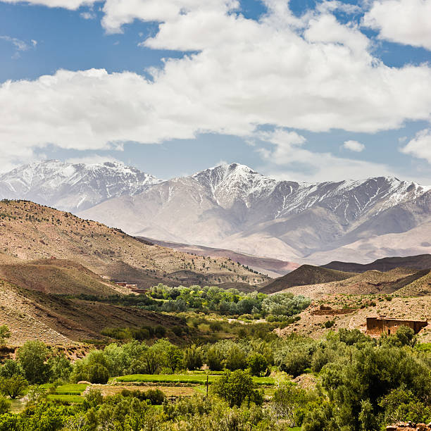 Beautiful image of the Atlas Mountains of Morocco, with an achievement giving a lot of depth. Decorated with a sky full of clouds in daylight.