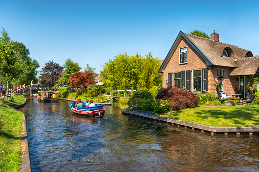 Giethoorn is a mostly car-free touristic village in the northeastern Dutch province of Overijssel. It’s known for its boat-filled waterways and centuries-old thatched-roof houses. The boats are tourboats for tourists.