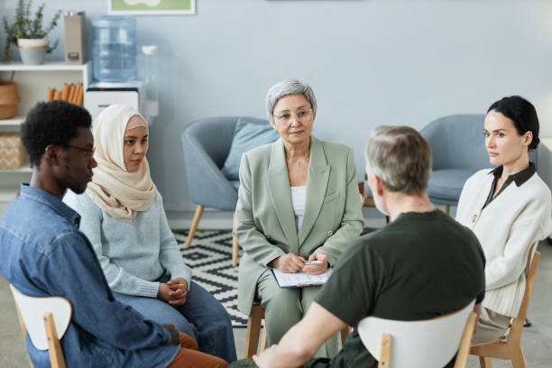 istock Confident mature female counselor consulting people with psychological problems 1550388079