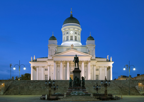 Evening view of the Finnish Evangelical Lutheran cathedral of the Diocese of Helsinki and monument to russian emperor Alexander II erected on the Senat Square of Helsinki in 1894 to commemorate his re-establishment the Diet of Finland in 1863.