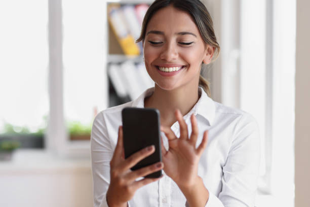 istock Young woman using a cellphone at home 1550397350