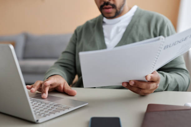 istock Black businessman working from home and reviewing financial documents 1550405208