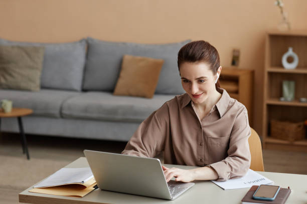 istock Young businesswoman enjoying work from home and using laptop 1550405214