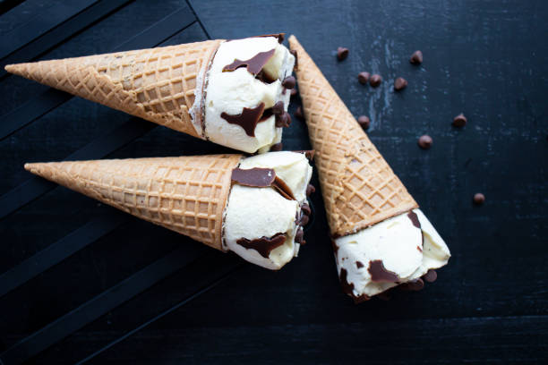 istock Cream ice cream cone,  with pieces of chocolate. 1550414533