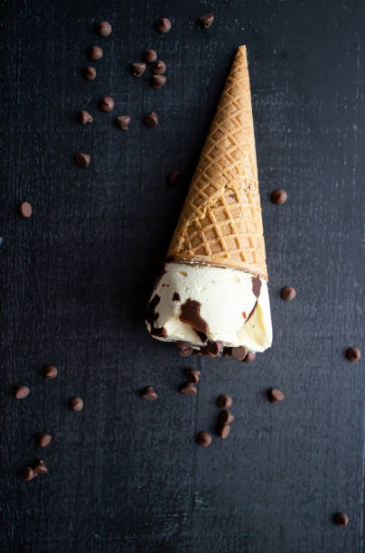 istock Cream ice cream cone,  with pieces of chocolate. 1550414534