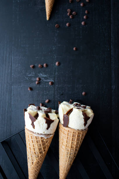 istock Cream ice cream cone,  with pieces of chocolate. 1550414535