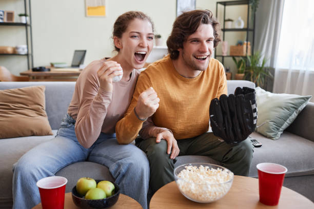 Couple cheering for sports match