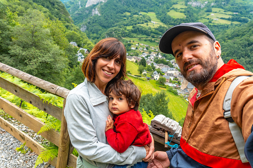 A family on a trail having fun in a Borce commune in the French Pyrenees and its beautiful mountains