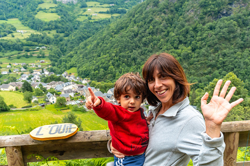 Mother and son on a trail having fun in a Borce commune in the French Pyrenees and its beautiful mountains