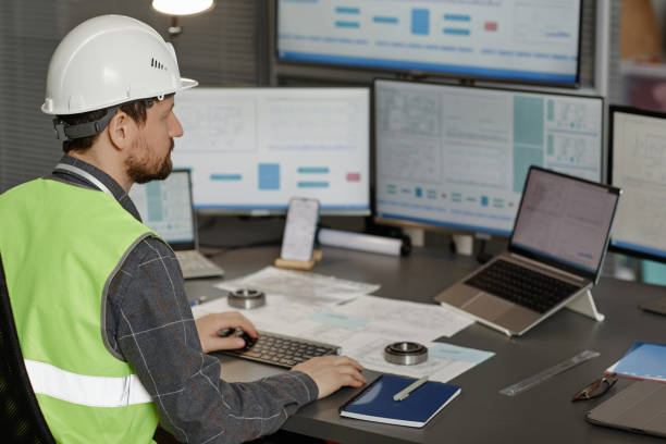 istock Back view of male construction engineer wearing hardhat at workplace 1550428220