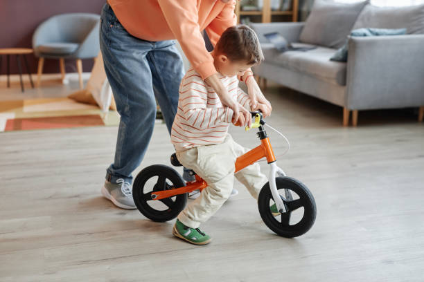 istock Boy with down syndrome playing with runbike 1550440300