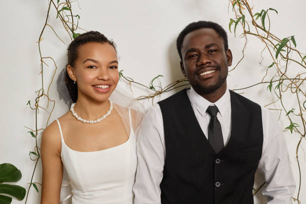 Elegant bride and groom smiling at camera
