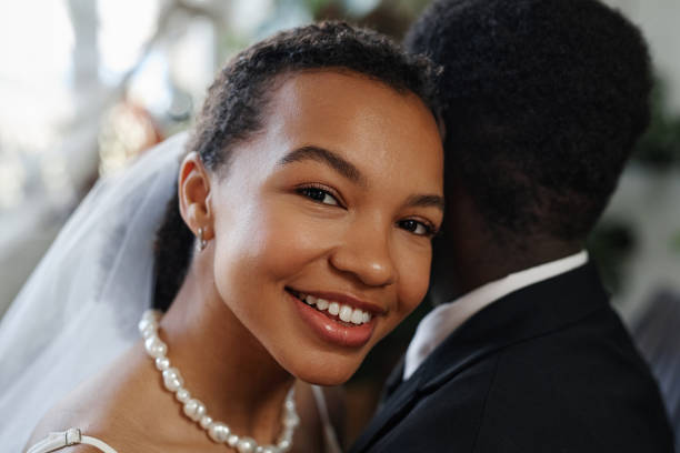 istock Close up black young woman smiling at camera with husband 1550450831