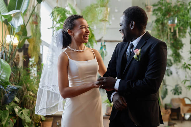 istock Black young couple getting married in tropical orangerie 1550450834