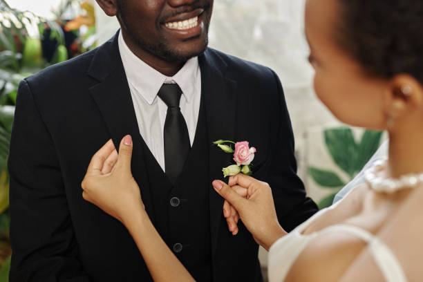 istock Black young couple getting married with bride adjusting jacket and boutonniere 1550450847