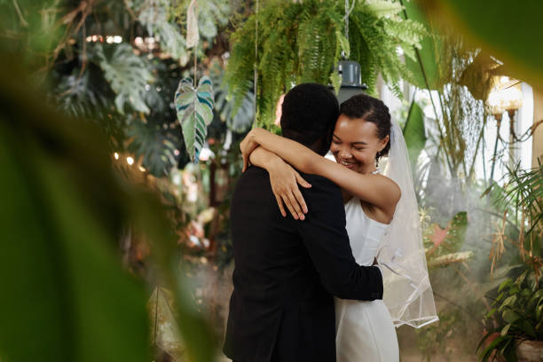 Black couple getting married and dancing together in orangerie