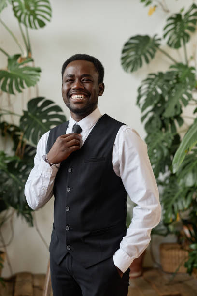 Handsome black man wearing tux as groom smiling at camera