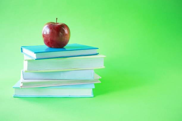 istock A stack of books and an apple on a green background, copy space
Back to school concept. 1550472492