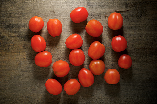 Cherry tomatoes on a wood table.