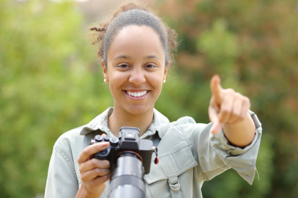 istock Black photographer pointing at camera 1550491260