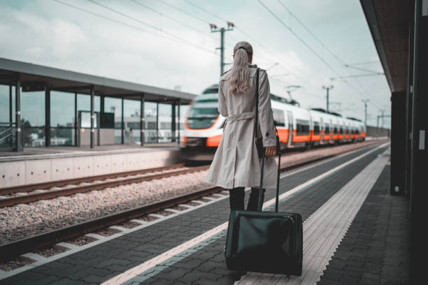 istock Business woman commuting to work with train 1550494982