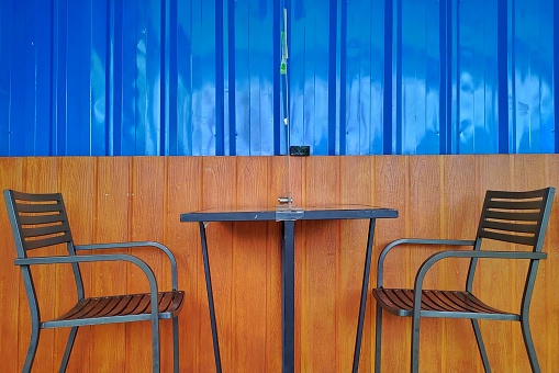 Two empty chair with a table in the center