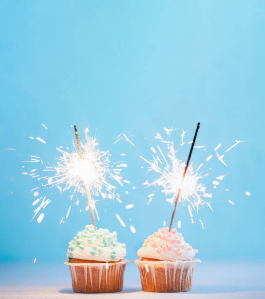 istock Two cupcakes decorated with sparklers, copy space 1550515995