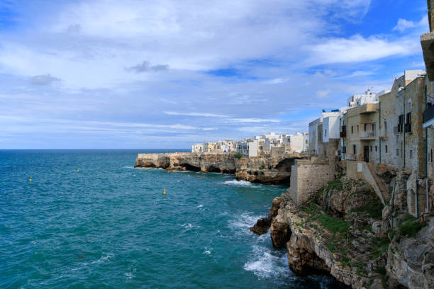Polignano a Mare, Italy. View of the village. Old buildings on a cliff by the sea. Italian architecture. Photos for backgrounds, wallpapers, postcards.