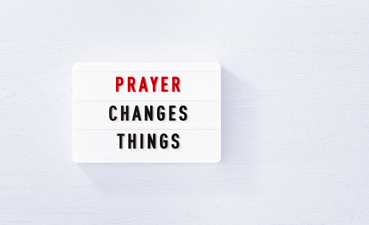 Prayer changes things white lightbox on white wood background. Horizontal composition with copy space.