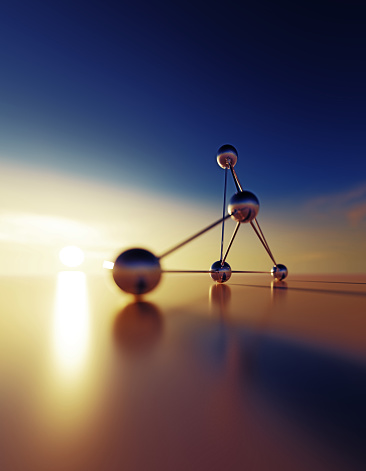 Connected spheres at sunset. Vertical composition with copy space.