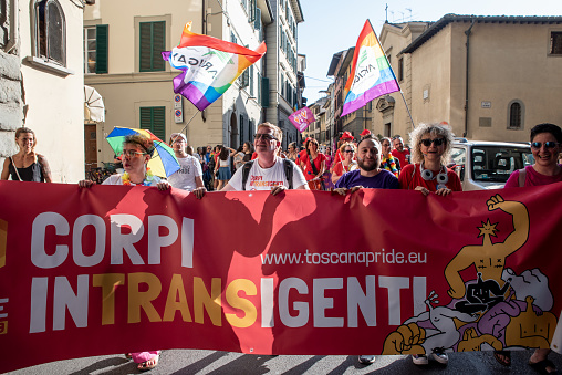 Florence, Italy - 2023, July 8: Crowds of demonstrators holds a banner that reads INTRANSIGENT BODIES, during the “Toscana Pride” LGBTQ  parade